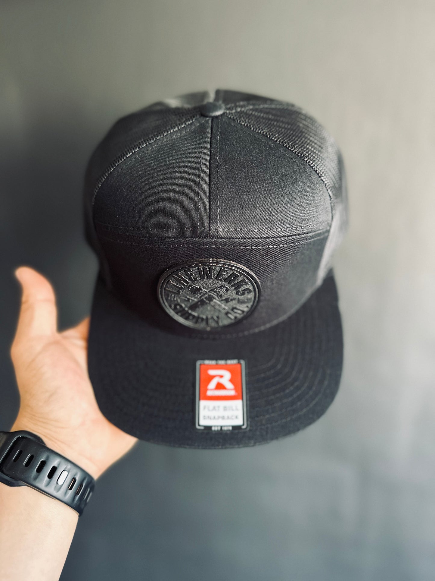 168-LP Richardson Seven-Panel Trucker Cap with Black Leather Patch